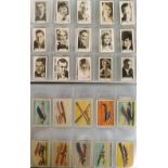Trade cards, 2 albums sorted alphabetically containing various part-sets and odds, issuers include