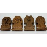 Four 19th Century Black Forest carved pocket watch holders