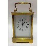 A brass cased carriage timepiece with 2.5in white enamel dial with black Roman Numerals, the case