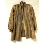 A ladies fur coat, with brown silk lining, length 90, size 10/12.