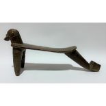 An African tribal Lobi head rest, Burkina Faso, with carved head on slightly dished seat and with