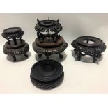 Six various Chinese circular hardwood carved and pierced vase stands, the largest diameter 19cm