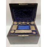 Victorian Coromandel brass inlaid vanity box, the hinged-lid revealing eight silver lidded bottles