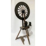 An antique elm spinning wheel, signed 'DANIEL GRAY STRAVEN', height 126cm.