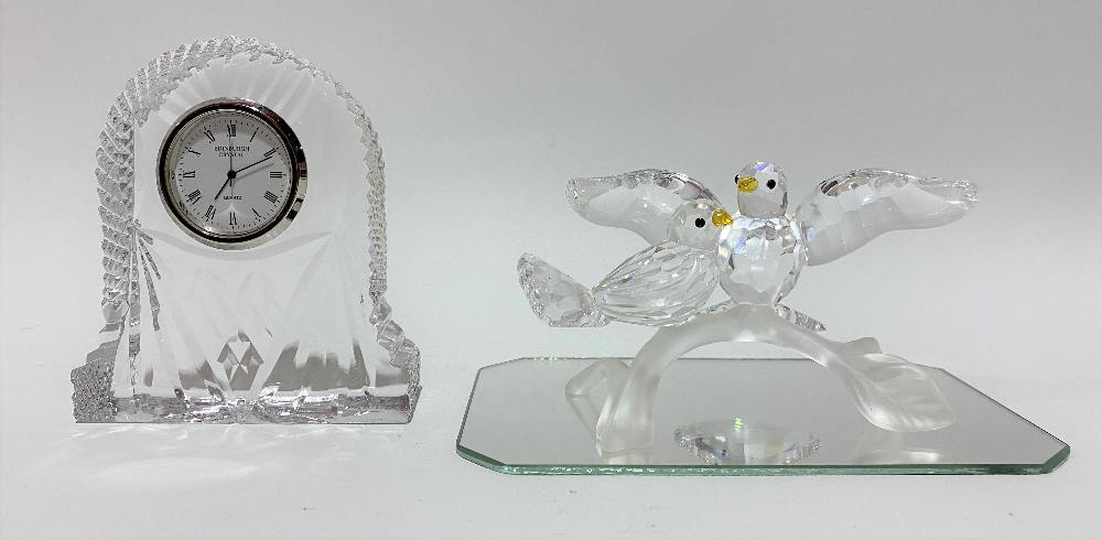 Swarovski crystal bird group upon a mirrored base and with an original cylindrical box; together