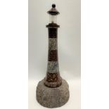 A large red and grey Cornish serpentine sectional lighthouse table lamp, height 64.5cm