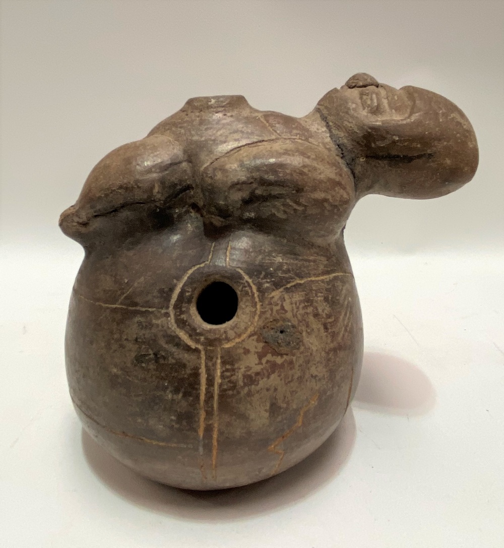 A possibly pre-Columbian, Chimu terracotta pot applied to the top with a figure on an ovoid base,