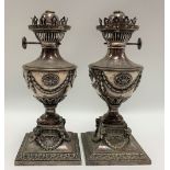 Pair of silver plate on copper Neo Classical style oil lamps, of pedestal urn form cast with