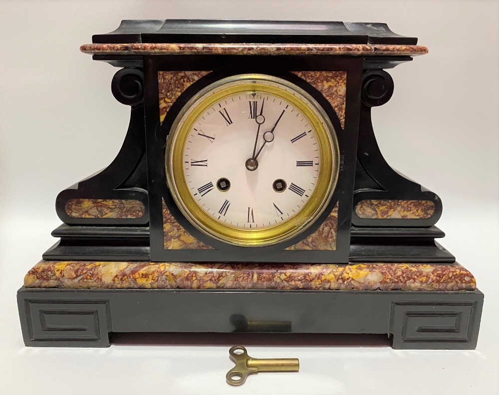 A black and red veined two train clock garniture, the 3.5 inch white enamel dial with roman