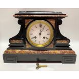 A black and red veined two train clock garniture, the 3.5 inch white enamel dial with roman