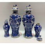 Pair of Chinese blue and white underglaze baluster lidded vases each foliate decorated and with