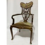 Two Edwardian elbow chairs by the same maker, one with an eccentric carved, pierced and