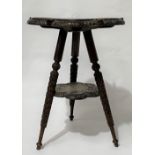 Anglo-Indian carved teak tripod table, the lobed top foliate scroll carved and with six crocodiles