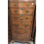 20th Century walnut veneered tall bow front chest of six graduated drawers upon ogee bracket feet,