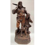 A Swiss Black Forest carved wood group depicting a medieval gentleman holding a crossbow at his