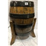 Oak coopered barrel raised on three outswept feet, height 53cm
