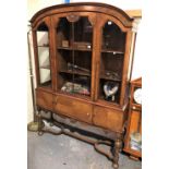 A Dutch style walnut veneered inlaid display cabinet, the central glazed door with carved scallop