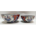 Pair of Japanese graduated porcelain underglaze blue and enamel painted bowls, the well decorated