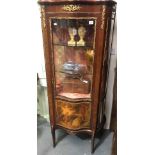 Louis XVI style mahogany gilt metal mounted serpentine display cabinet, the glazed door with a lower