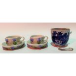 Pair of miniature German porcelain forget-me-not encrusted tea cups and saucers painted with