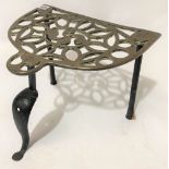 A 19th Century brass pierced trivet upon cast iron supports, width 37cm