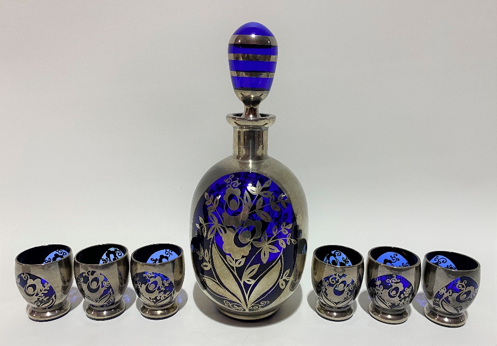 A silver overlay cobalt blue liqueur set for six comprising decanter and stopper and six tumblers,
