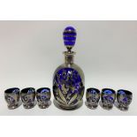 A silver overlay cobalt blue liqueur set for six comprising decanter and stopper and six tumblers,