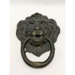 A large bronze lion head and ring handle door knocker, height overall 30cm x 22cm