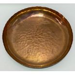 A Newlyn Copper shallow bowl, stamped 'Newlyn', diameter 13cm; together with a Newlyn Copper booklet