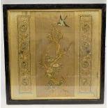 A Chinese silk embroidered panel centrally decorated with a blossoming tree with bird and flanked by