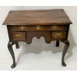 A Georgian oak lowboy, the moulded top over a long drawer and two short drawers with shaped apron
