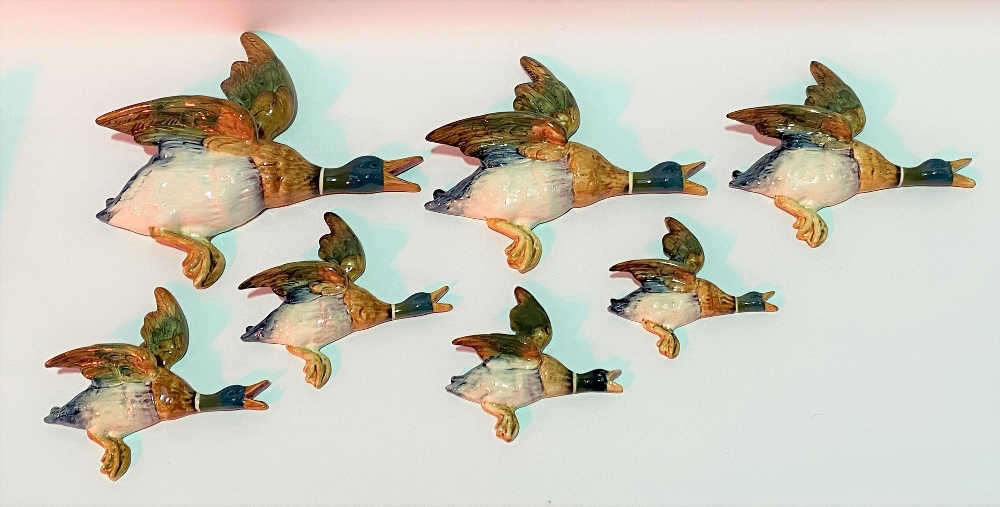 Set of seven Beswick Pottery flying duck wall plaques, no. 596-02 to 596-04 including pair of 596-