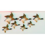 Set of seven Beswick Pottery flying duck wall plaques, no. 596-02 to 596-04 including pair of 596-