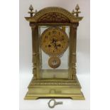 A good French brass four glass two train clock by J. Marti & Cie, the 3.5 inch brass dial with black
