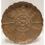 Tibetan copper embossed circular wall plaque inset with turquoise, the central well decorated the
