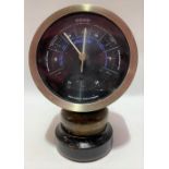 An aneroid barometer with 4 inch black dial and within wood and ebonised case by Short & Mason,