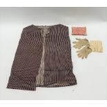 A pair of Victorian child's gloves, a pin cushion and a child's brown striped cotton waistcoat.