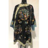 A 20th Century Chinese silk embroidered robe decorated with roundels of figures in a trellis