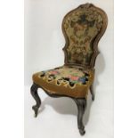 Victorian walnut framed nursing chair with tapestry upholstered back and seat and on cabriole legs