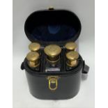 Cased set of five gilt metal screw lid scent bottles within oval fitted black Moroccan leather