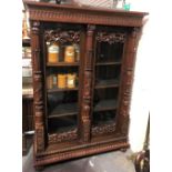 A good late 19th century Anglo-Indian rosewood bookcase, the moulded cornice over a pair of glazed