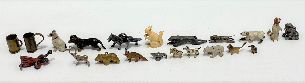 Four cold painted bronze miniature dog figures; together with miniature cold painted bronze lion,