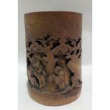 A Chinese bamboo carved brush pot, decorated with three sages underneath trees, height 16cm