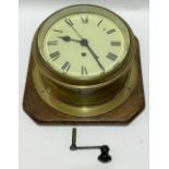 A good single fusee ship's brass bulkhead wall clock, with 8 inch cream enamel dial with black roman