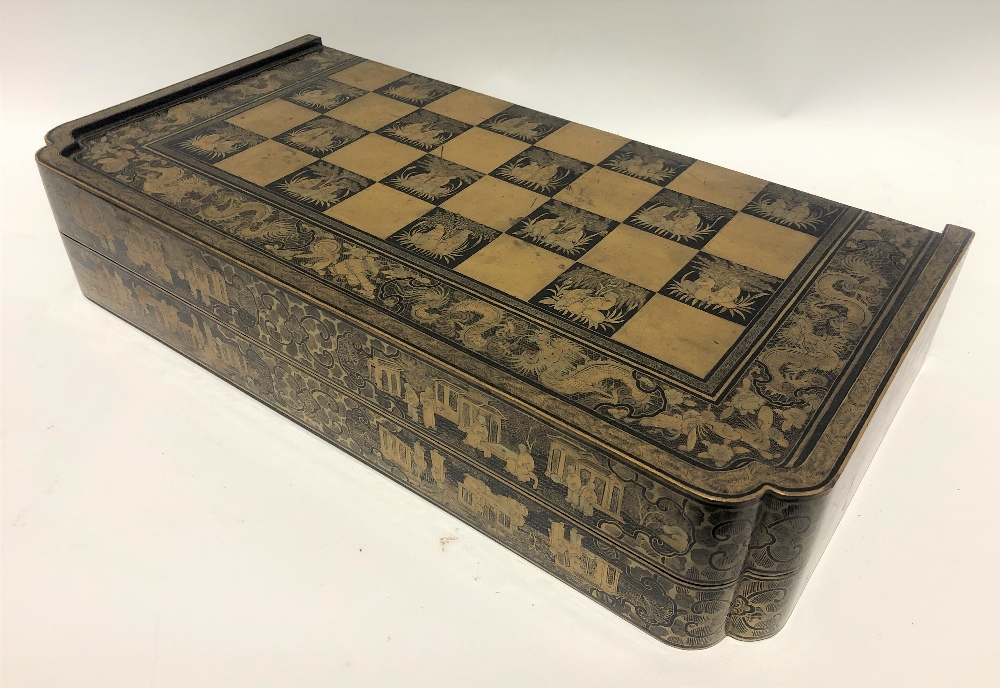 A 19th Century Chinese export black lacquer and gilt decorated hinged games box, the lid and base