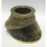 An early 20th century brass mounted horse hoof ashtray, the rim inscribed 'Phil 7 Jan 1913', with
