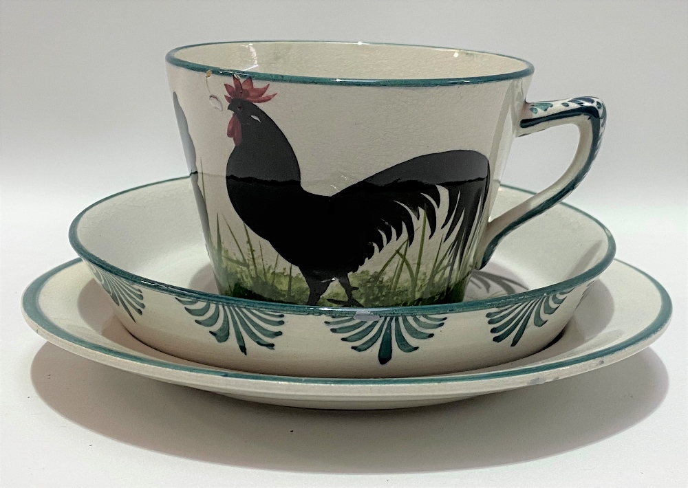 A Wemyss ware black cockerel decorated trio impressed and printed marks and retailed for T.