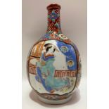 Japanese ovoid bottle vase of lobed form decorated in enamels, painted with a reserve to one side