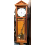 A 20th century two-train Vienna wall clock in architectural case, the 7in white enamel dial with