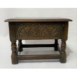 An 18th century style oak work table, the hinged top over a lunette leaf carved front, width 47.